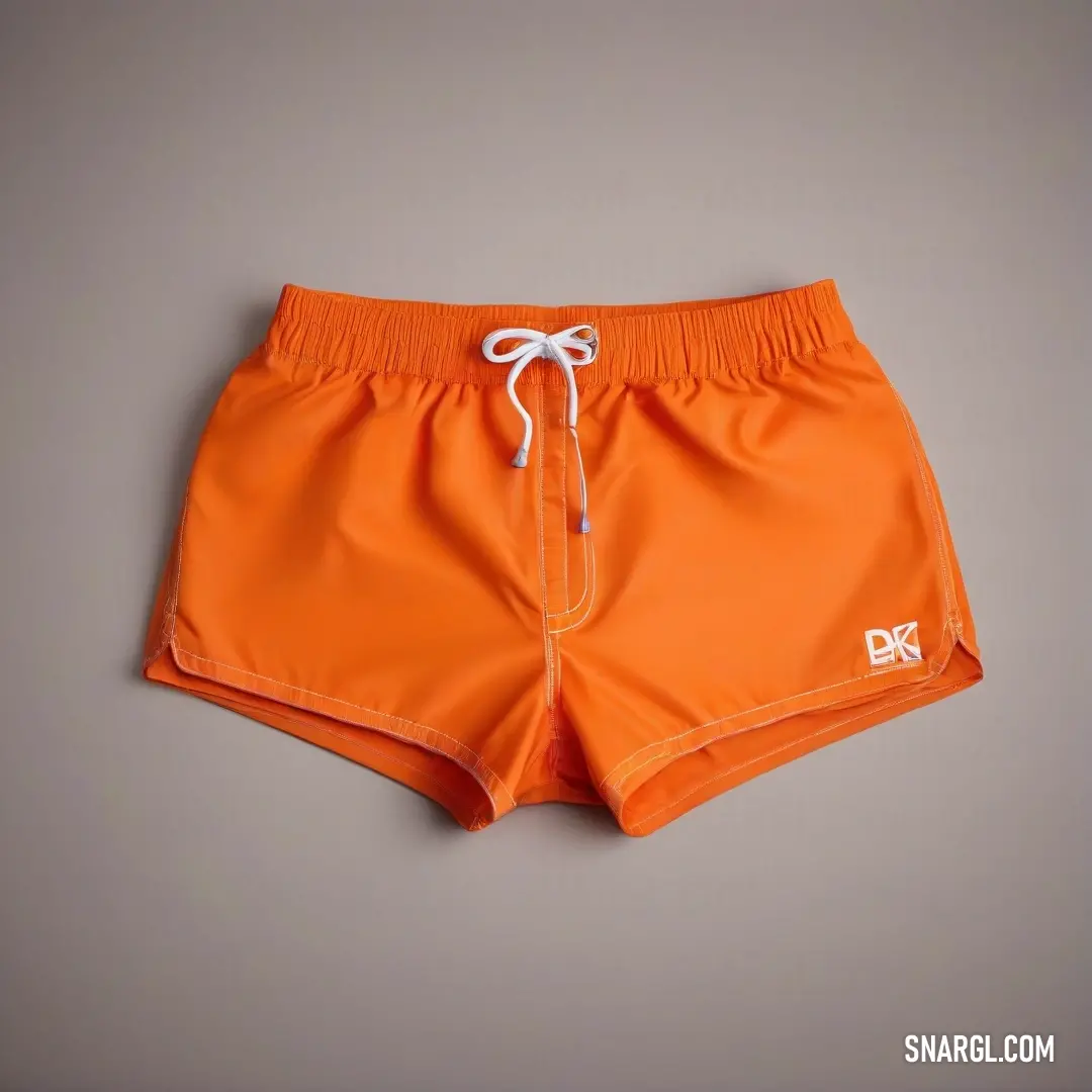 Pair of orange swim shorts with a white string on the side of the shorts. Color RGB 210,105,30.