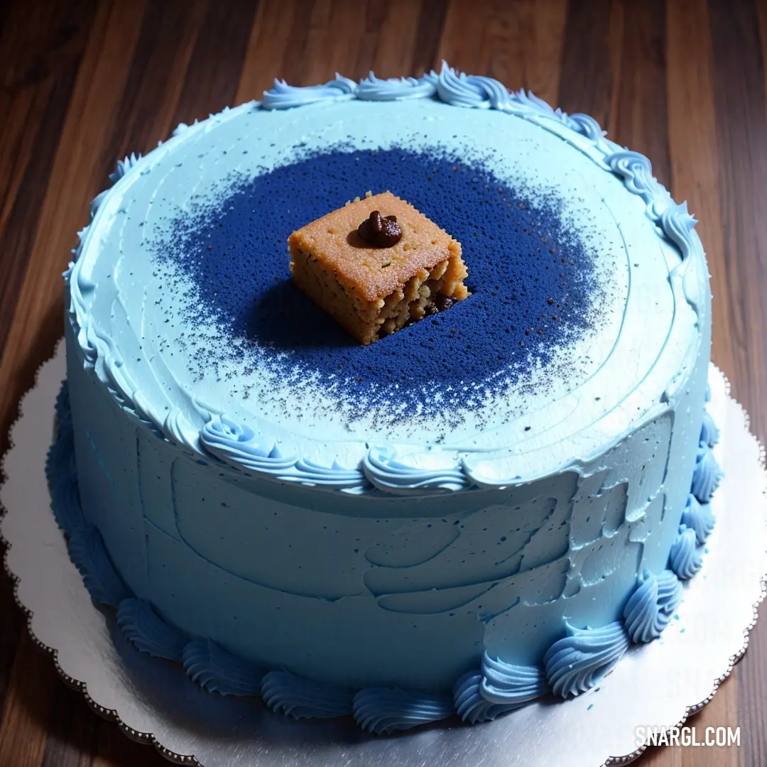Blue cake with a piece of cake on top of it on a wooden table with a white plate