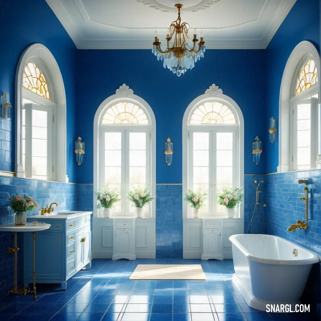 Cool black color. Bathroom with blue walls and a chandelier hanging from the ceiling and a white bathtub in the middle