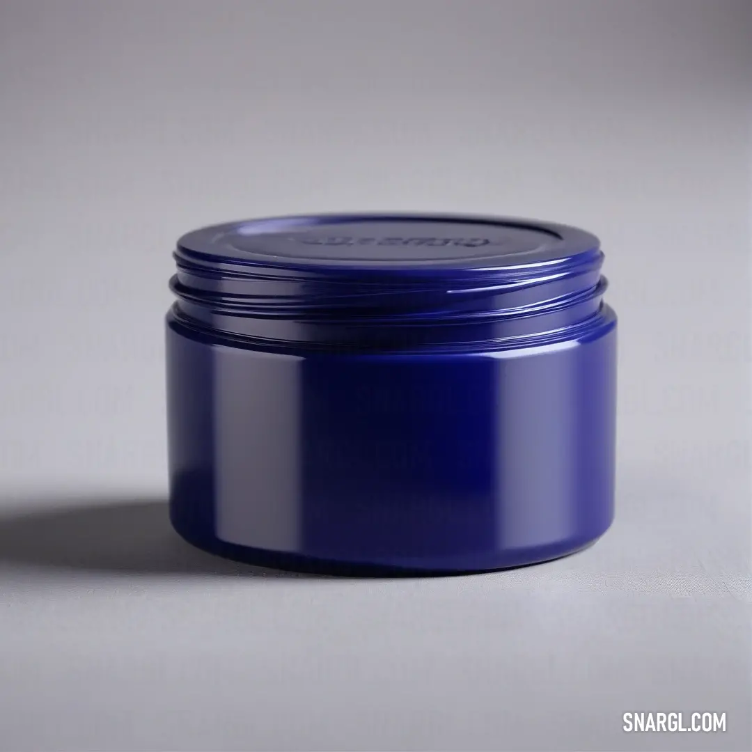 Blue jar of cream on a table top with a white background. Example of #002E63 color.