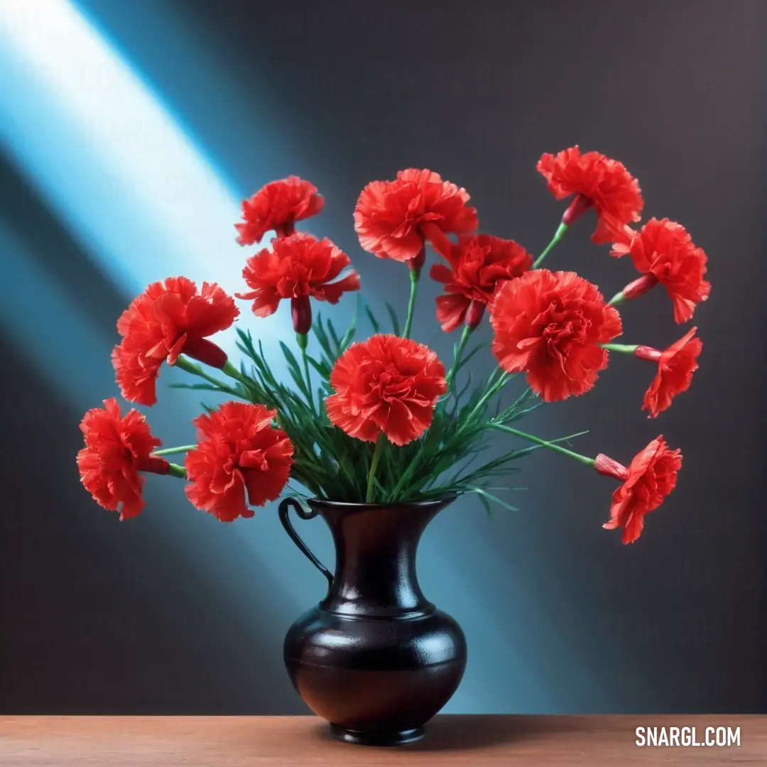 Coral red color. Vase with red flowers in it on a table with a blue light behind it and a black background