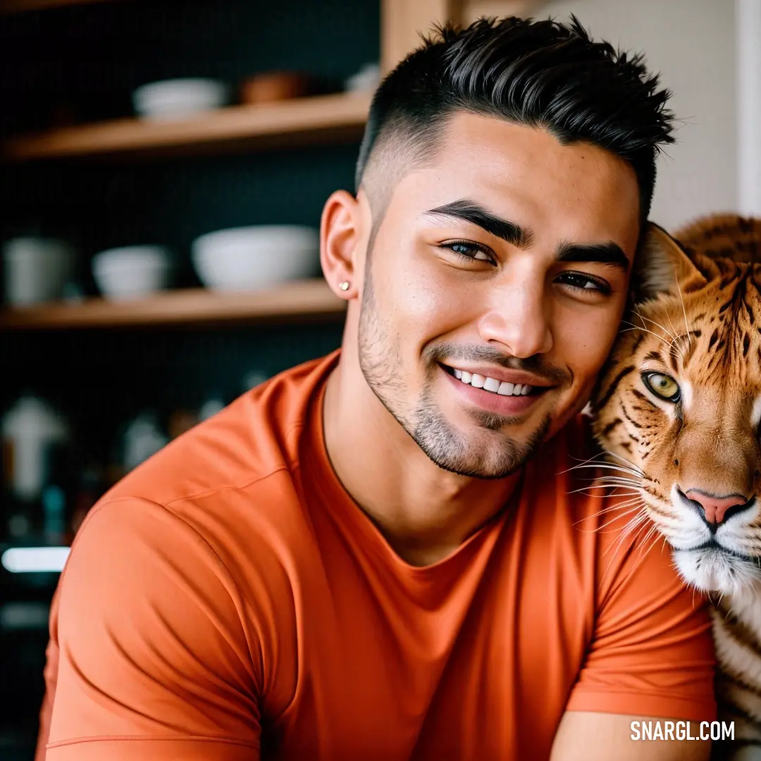 Man holding a tiger in his arms in a kitchen with a shelf behind him and a tiger on the other side of the man. Example of Coral color.