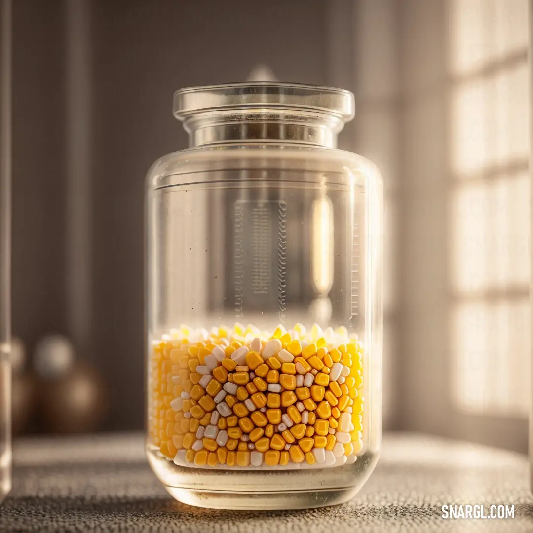 Jar filled with corn on top of a table next to a window with a curtain behind it