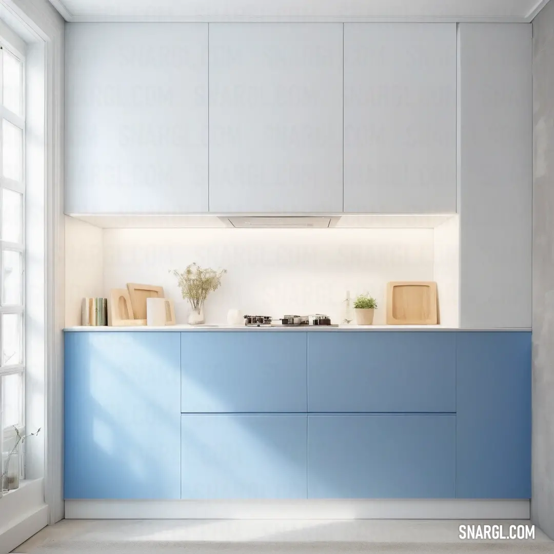 Kitchen with a blue counter and white cabinets and a window with a white curtain on it and a vase with flowers