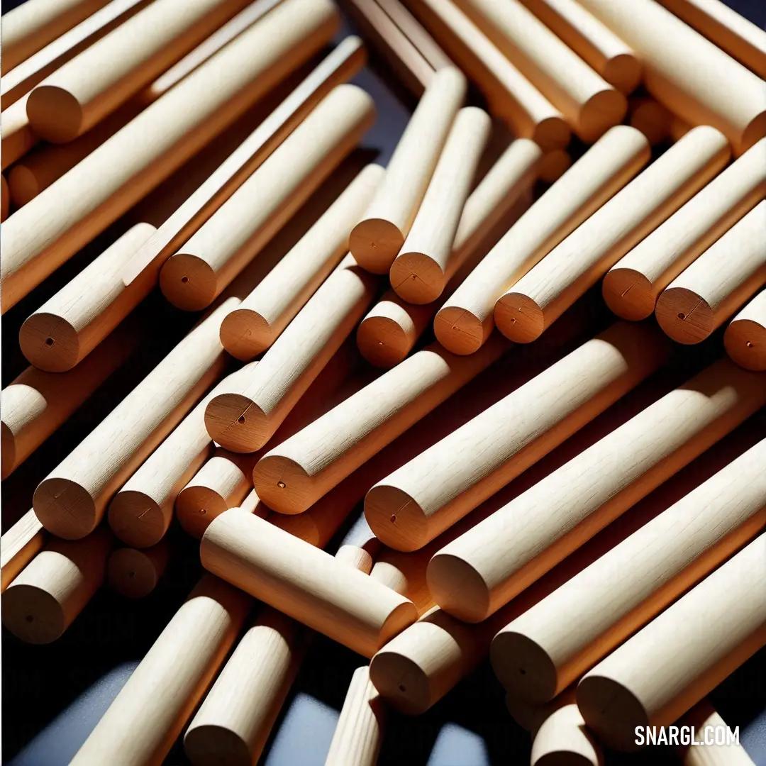 Pile of wooden dowels on a table top with a blue background. Example of #FFF8E7 color.