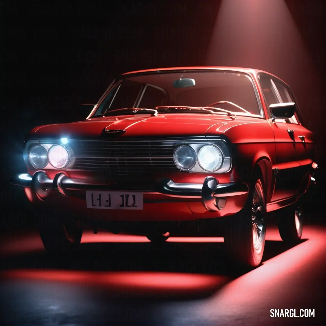 Crimson color. Red car with a light on it's headlight is shown in a dark room with a spotlight