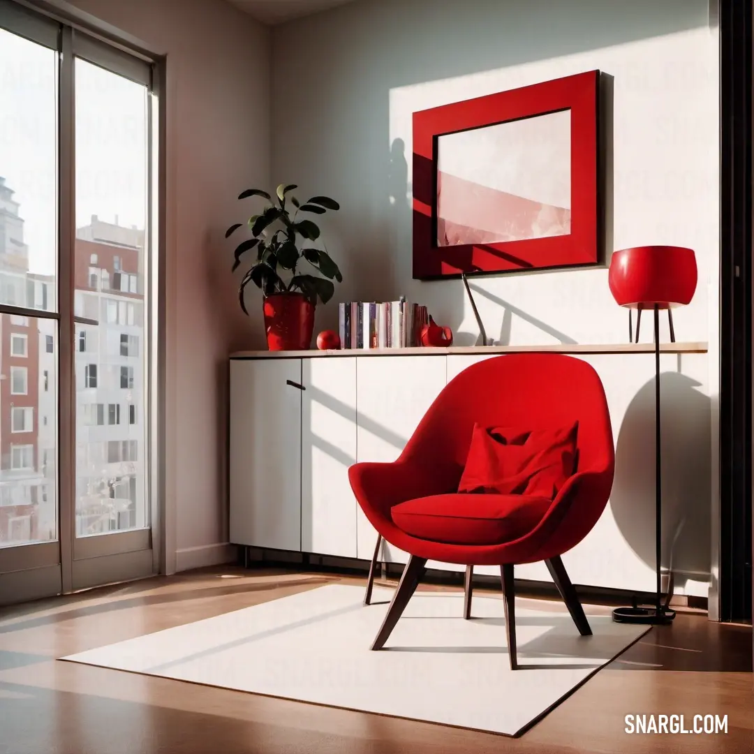 Red chair in a living room next to a white table and a window with a red picture frame. Example of CMYK 0,91,73,14 color.