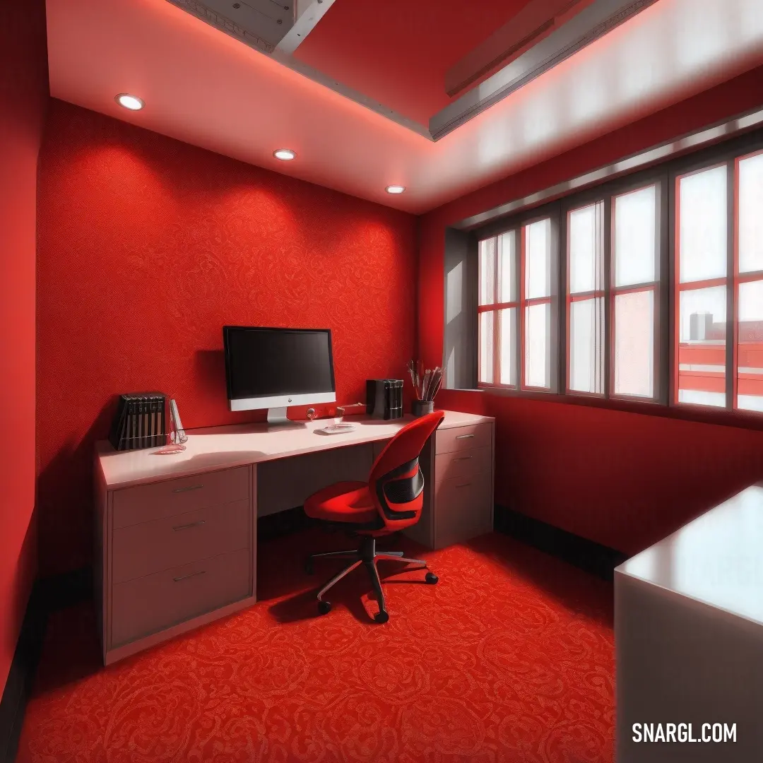 Red office with a desk and a computer monitor on it's desk and a red carpeted floor
