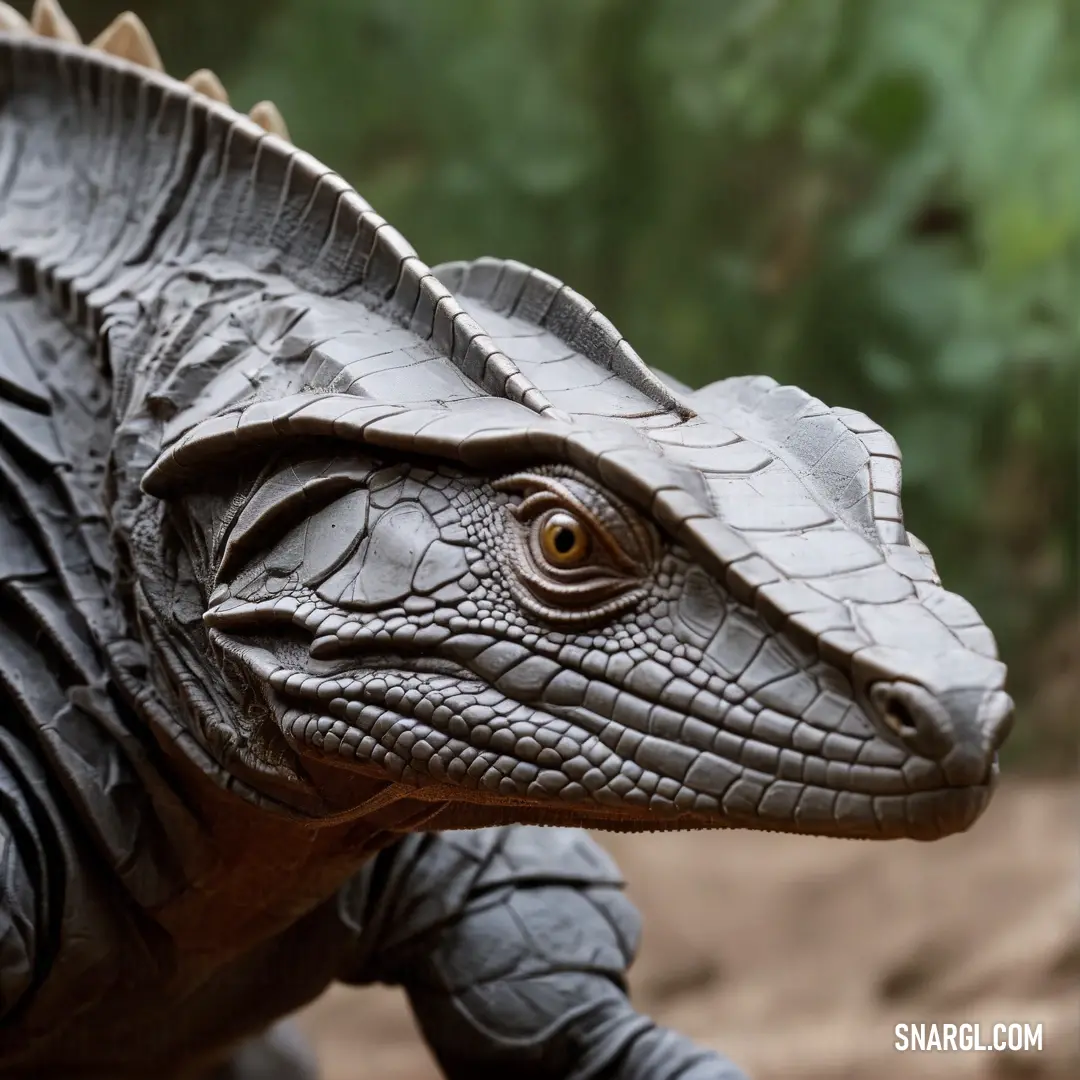 Close up of a toy Cyclura with a blurry background