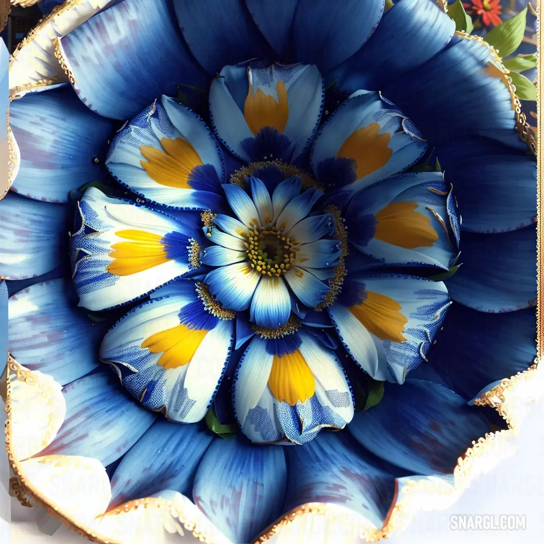 Blue and yellow flower is in a decorative bowl with gold trimmings and a gold border around the center. Color CMYK 100,100,0,45.