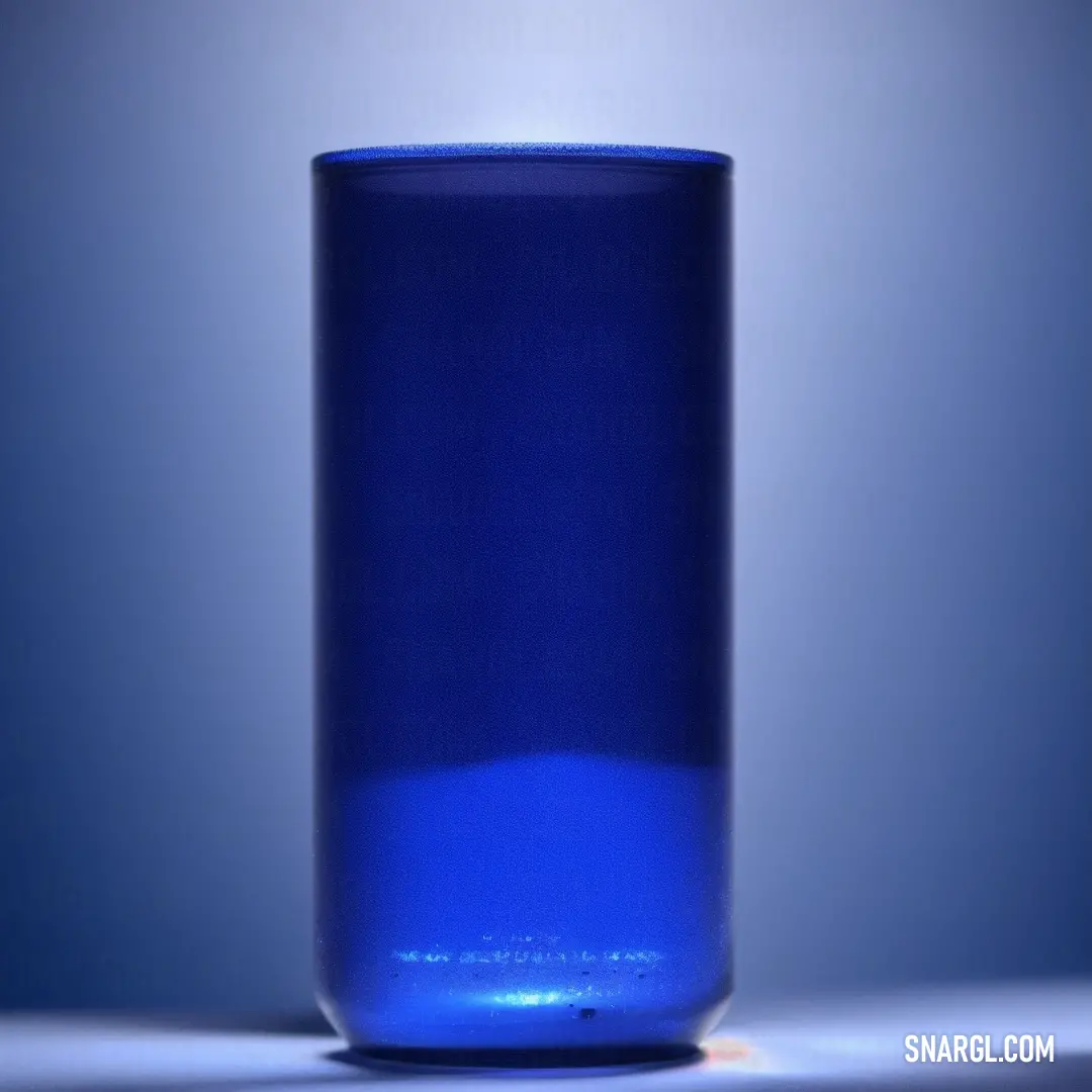Blue glass bottle is on a table with a light shining on it's side and a shadow on the floor