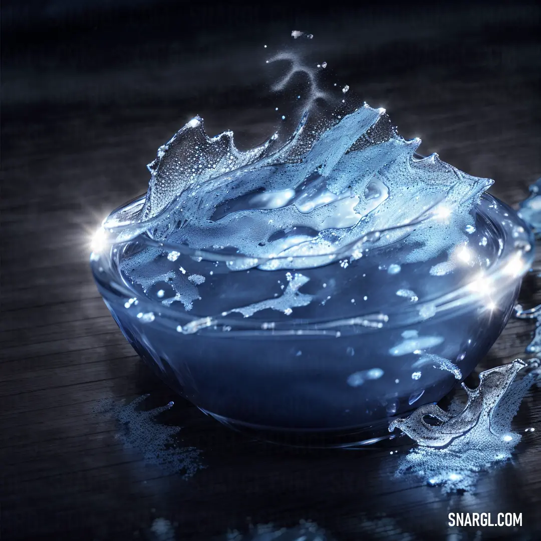 Bowl of water with a splash of water on it and a chain of water droplets on the surface