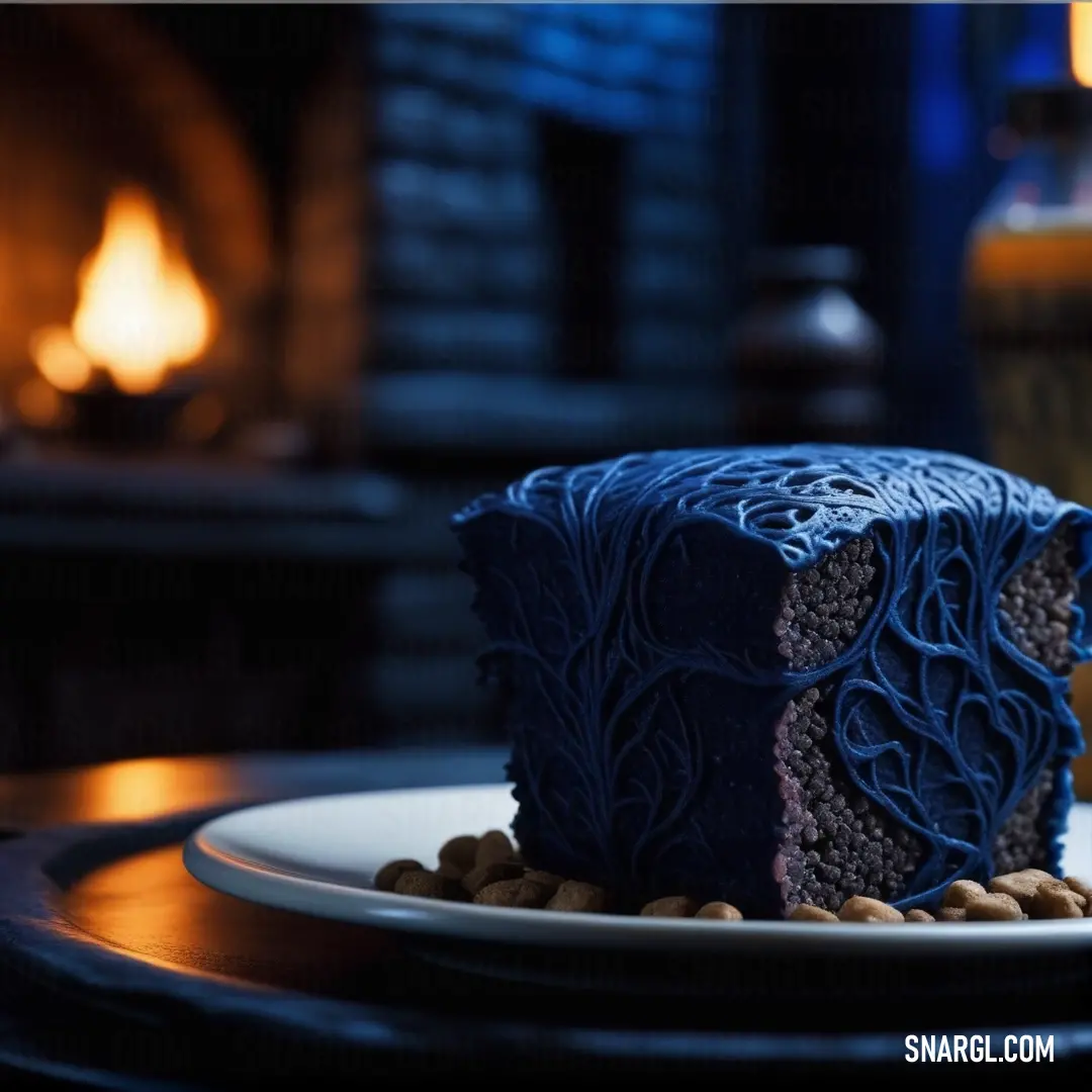 Piece of cake on a plate in front of a fireplace with a lit candle on it. Example of #08457E color.