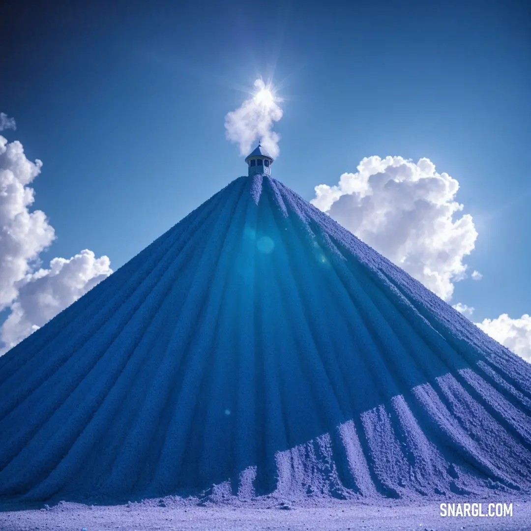 Large blue mound of sand with a sky background
