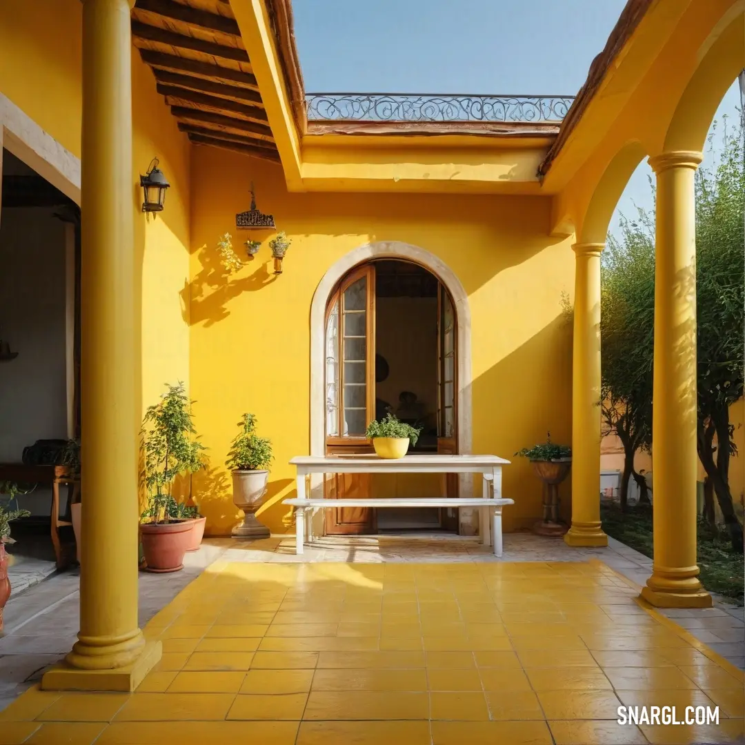 Yellow house with a white bench and potted plants on the porch and a yellow wall and ceiling. Color Dark goldenrod.