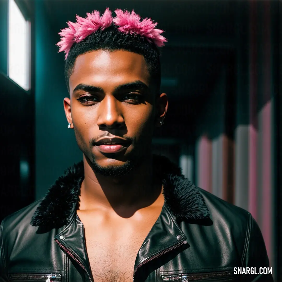 Man with a pink mohawk standing in a hallway with a black jacket on. Color RGB 26,36,33.