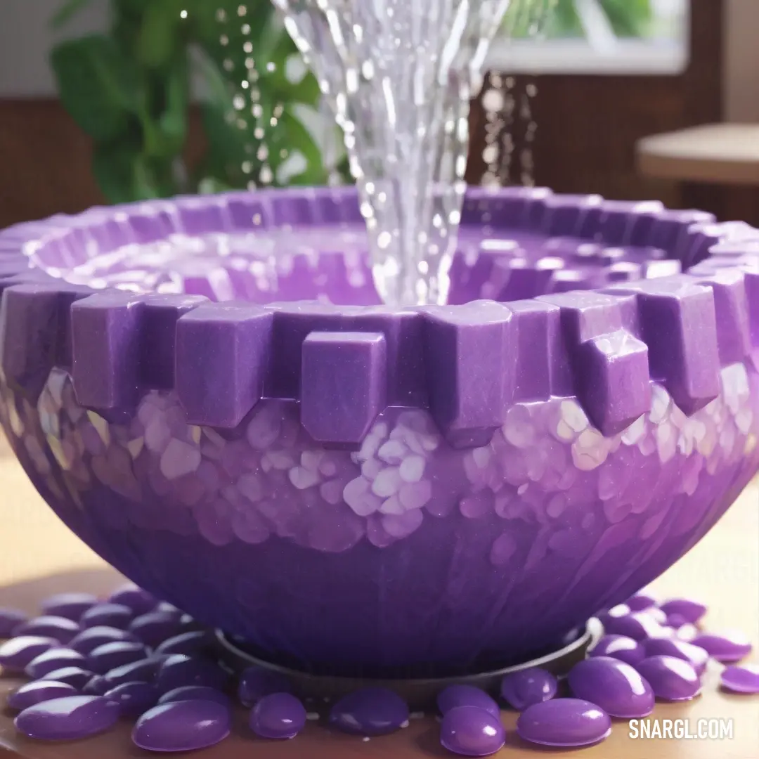 Purple bowl with a waterfall of water pouring out of it's center and purple rocks on the ground. Color Dark lavender.