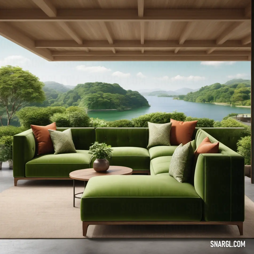 Green couch in a living room next to a table and a window with a view of a lake. Example of Dark olive color.