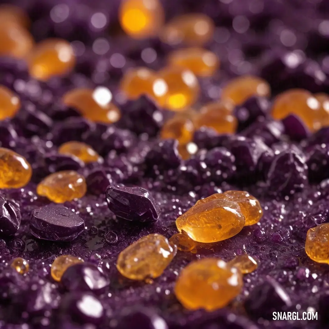 A close-up view of vividly colored rocks displays a striking combination of purple and yellow, glistening with droplets of water. The intricate details and colors evoke a sense of natural beauty and wonder in this serene yet dynamic landscape.