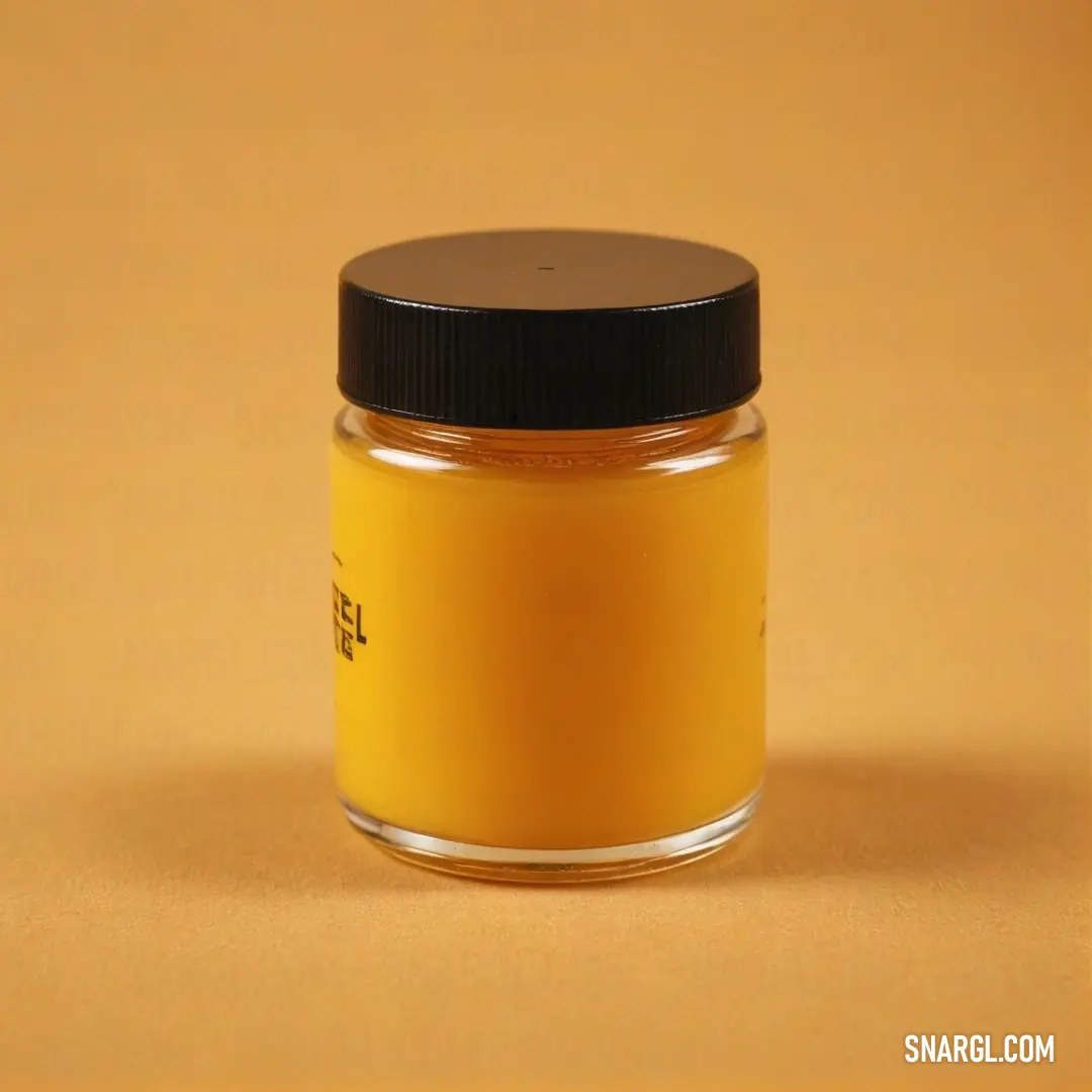 A jar of golden-yellow food paste stands out against a rich yellow backdrop, embodying the essence of dark orange. The smooth texture of the paste invites curiosity about its flavor while brightening the surroundings with warm hues.