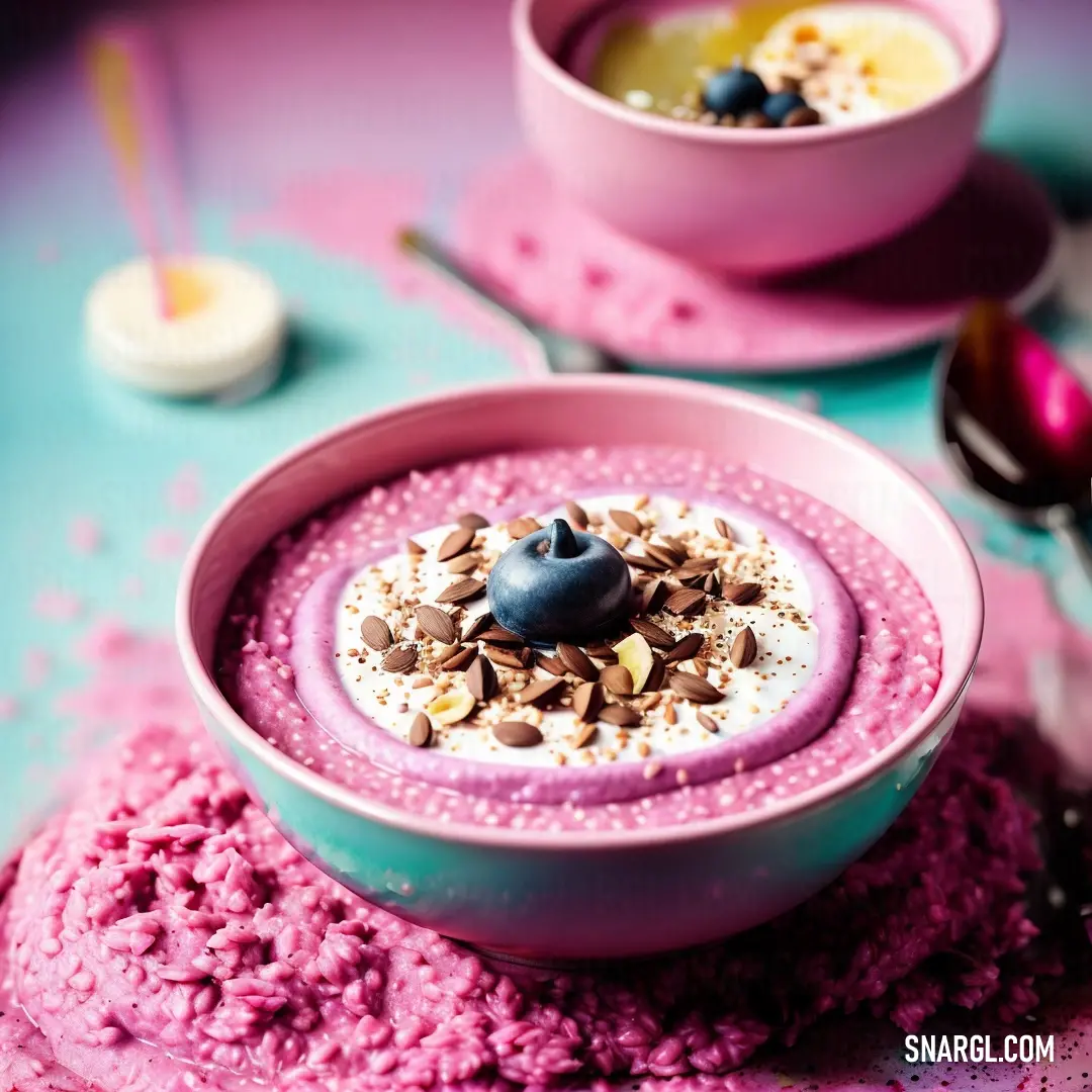 Dark pink color. Bowl of food with a spoon and spoon in it on a table with other bowls of food and spoons