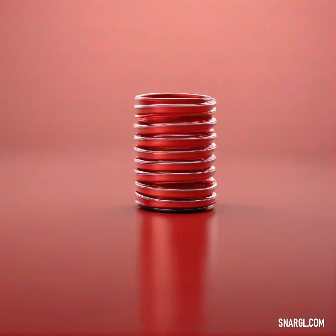 Stack of red plates on top of a red table top next to a red wall. Color #8B0000.