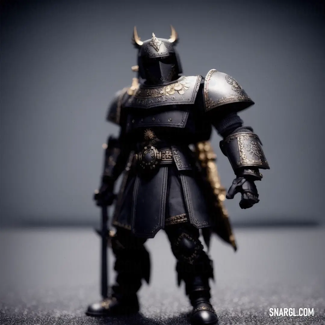 Toy figurine of a knight with a sword and armor on a table with a gray background