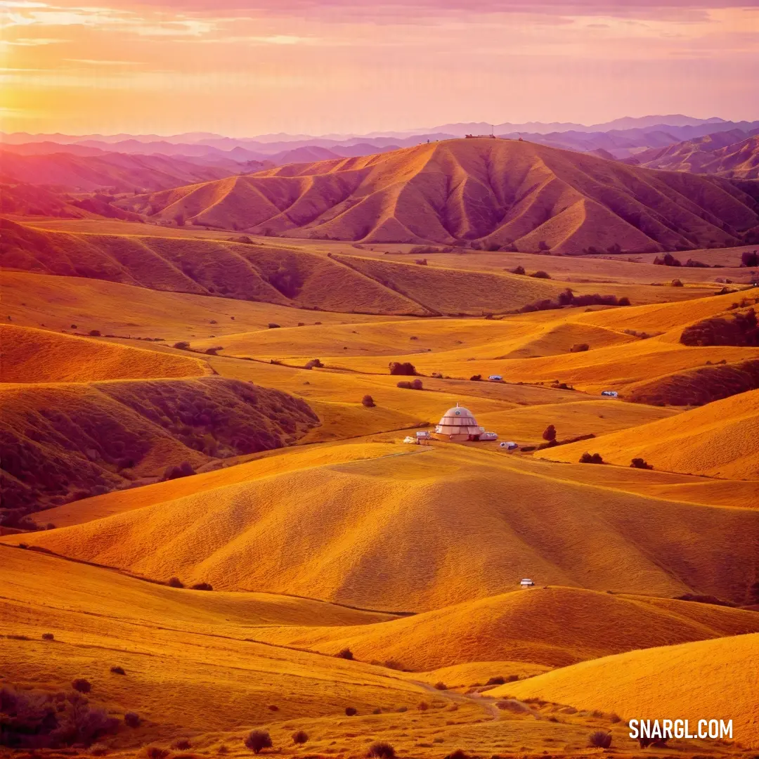 Beautiful view of a valley with a house in the middle of it and mountains in the background at sunset