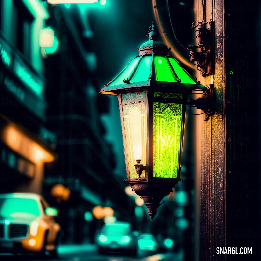 Green lamp on a street corner in the dark night time with a car passing by on the street