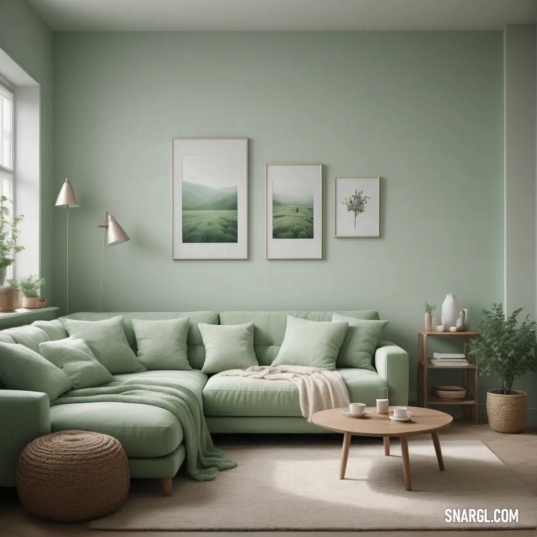 Living room with a green couch and a coffee table in front of a window with two pictures on the wall. Example of #567063 color.