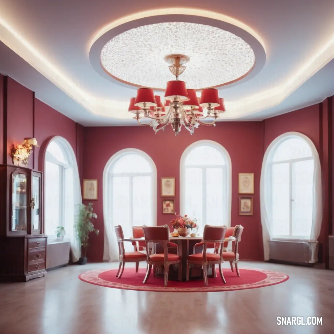 Dining room with a round table and red chairs and a chandelier hanging from the ceiling over a round rug. Color CMYK 0,62,55,20.