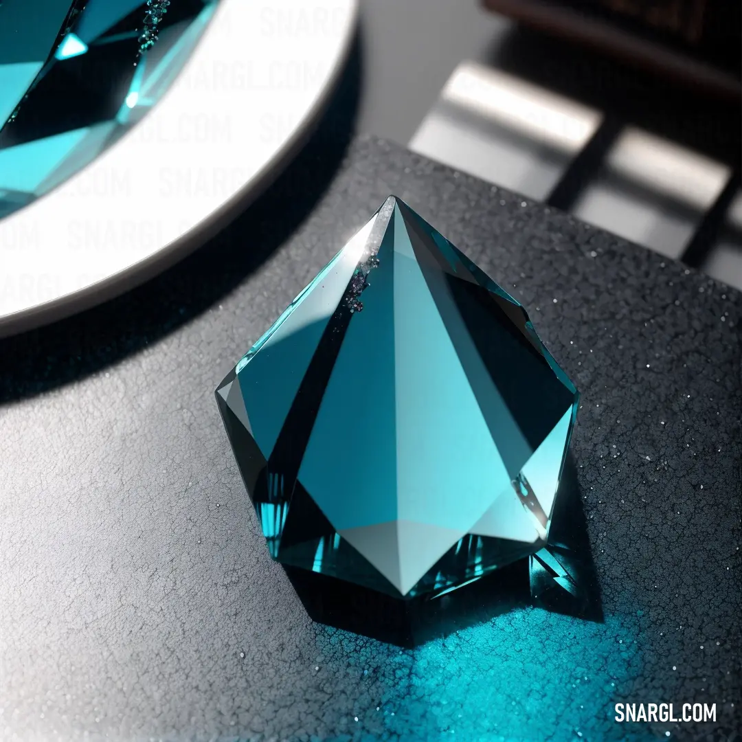 Blue diamond on top of a table next to a plate of food and a knife and fork