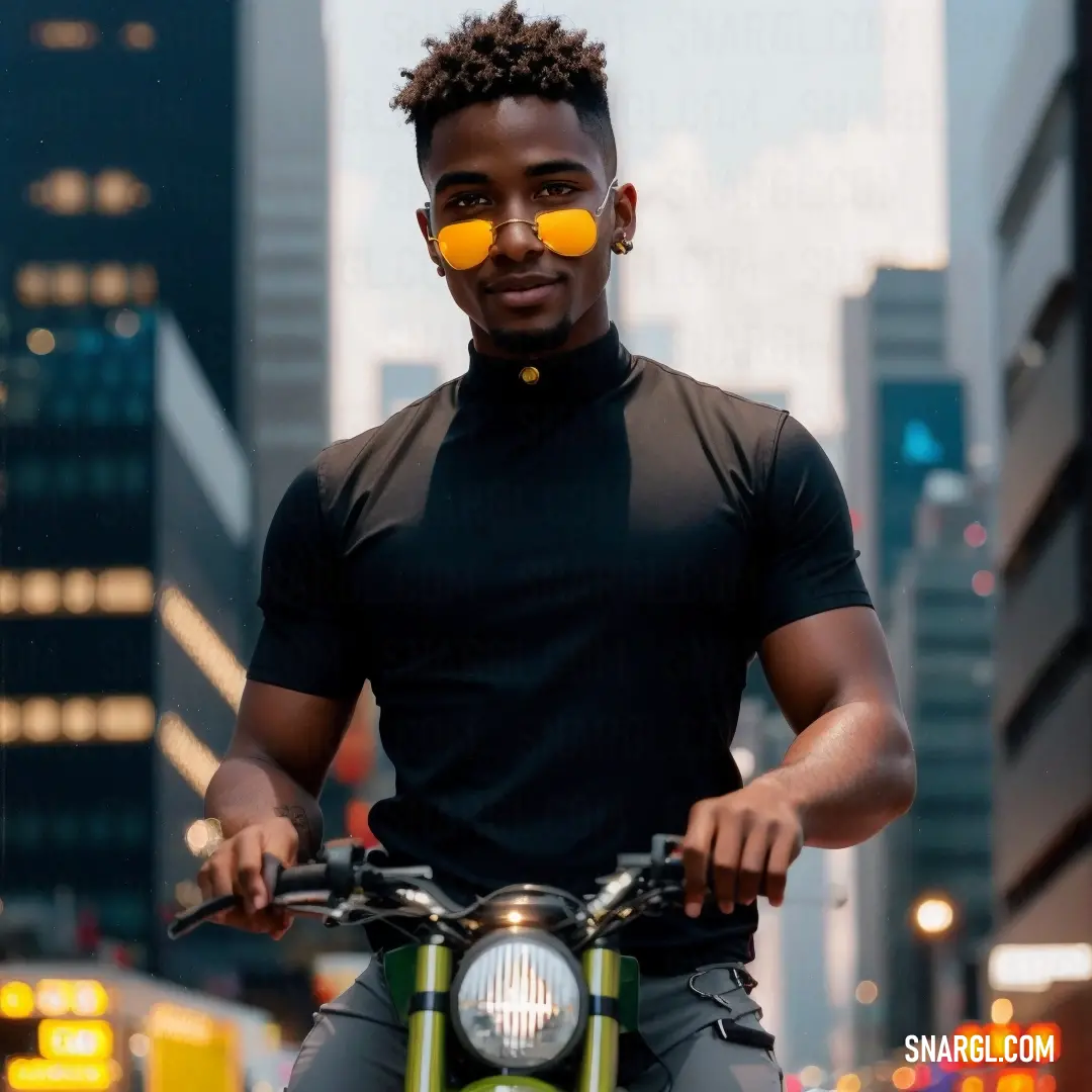 Man wearing sunglasses on a motorcycle in a city street at night with buildings in the background and a yellow light