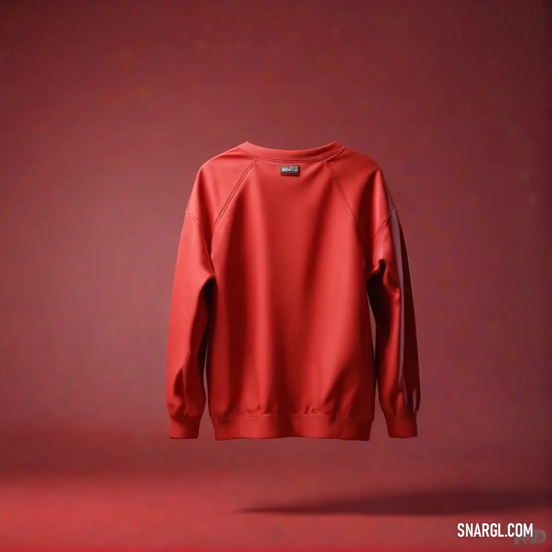 Red sweatshirt hanging on a red wall. Color Deep carmine pink.