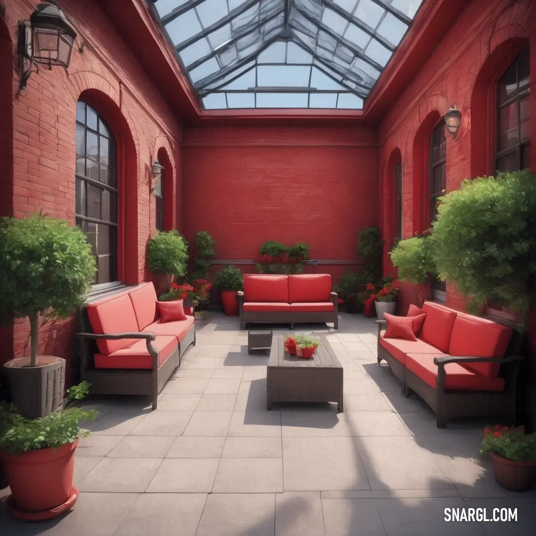 An inviting room filled with cozy furniture and lush plants, bathed in natural light from a skylight. The walls are painted in a deep red, creating a warm and vibrant atmosphere. The furniture adds a touch of comfort and style to this beautiful space.