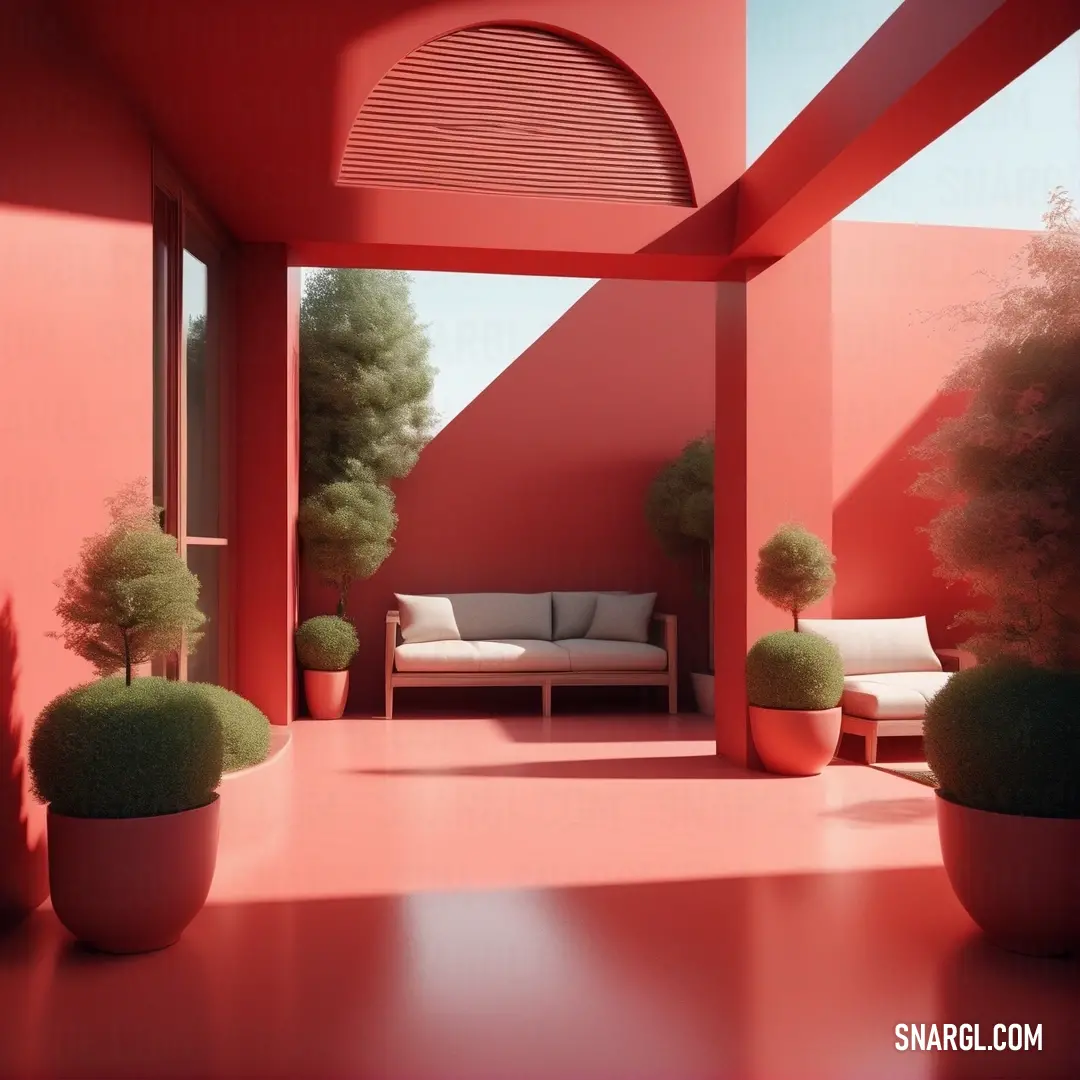 A cozy room with a comfortable white couch, surrounded by lush plants and a bold red wall. The vibrant deep carmine color of the wall adds warmth to the space, making it feel both stylish and inviting.