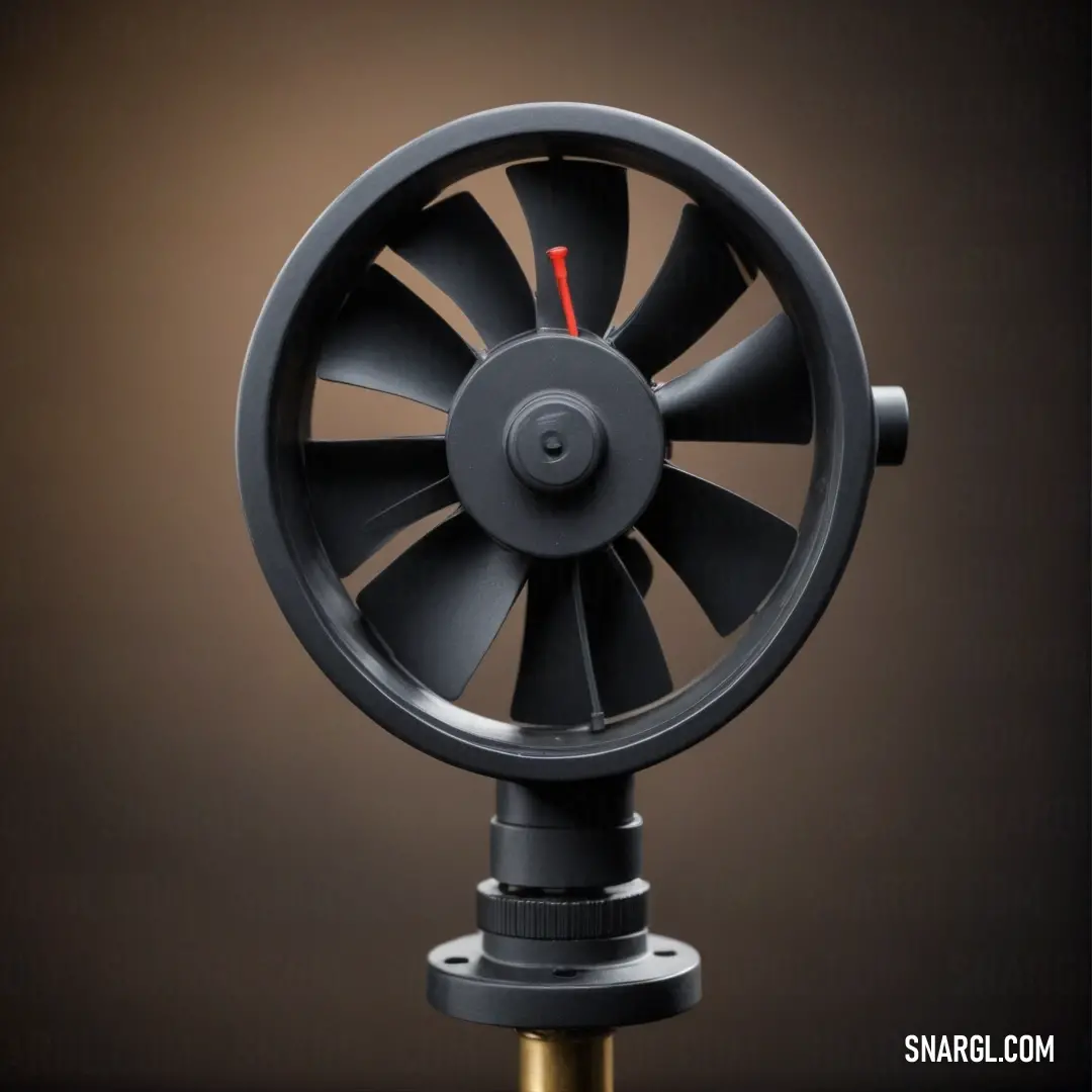 A stylish black fan rests on its sleek stand, illuminated by a red light against a warm brown background, creating an intriguing atmosphere of modern design and functionality.