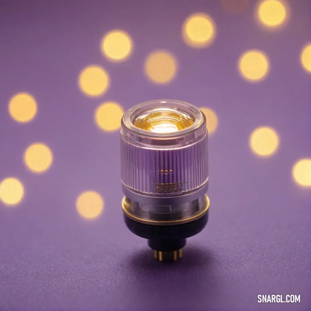 An artistic arrangement featuring a small camera lens set against a vibrant purple surface, with enchanting lights glimmering softly in the background, creating a captivating visual experience.