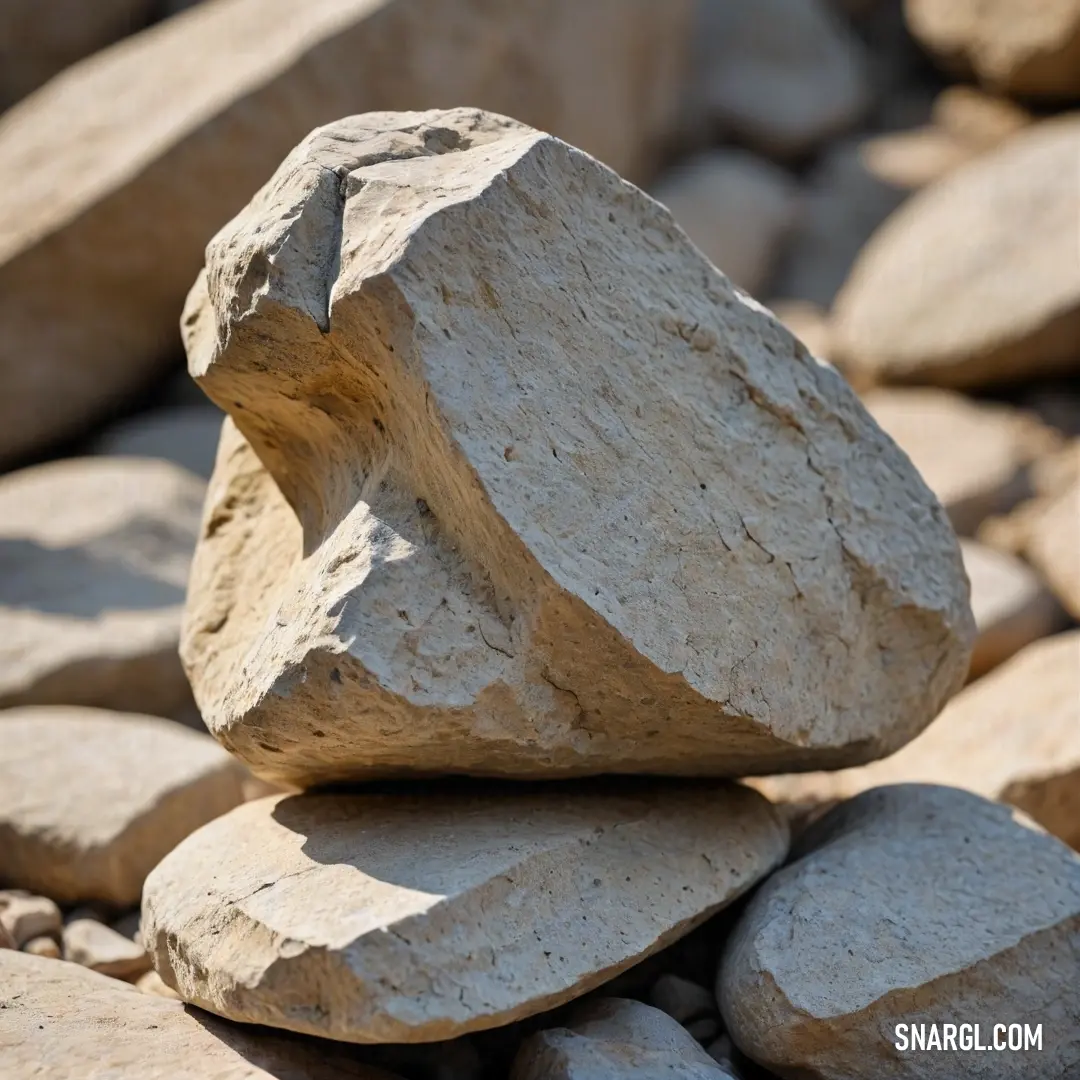 A fascinating rock stack growing taller and more intricate as it balances atop more rocks, showcasing both nature's architectural prowess and the unique, earthy palette of the stones. The harmonious arrangement speaks to a natural artistry found in the wi