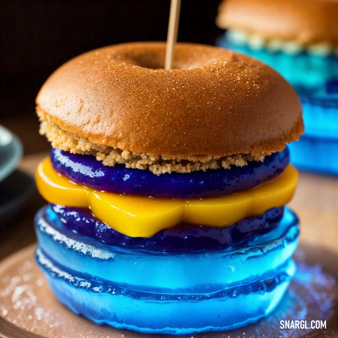 Blue and yellow hamburger with a toothpick sticking out of it's middle on a plate. Color #00BFFF.