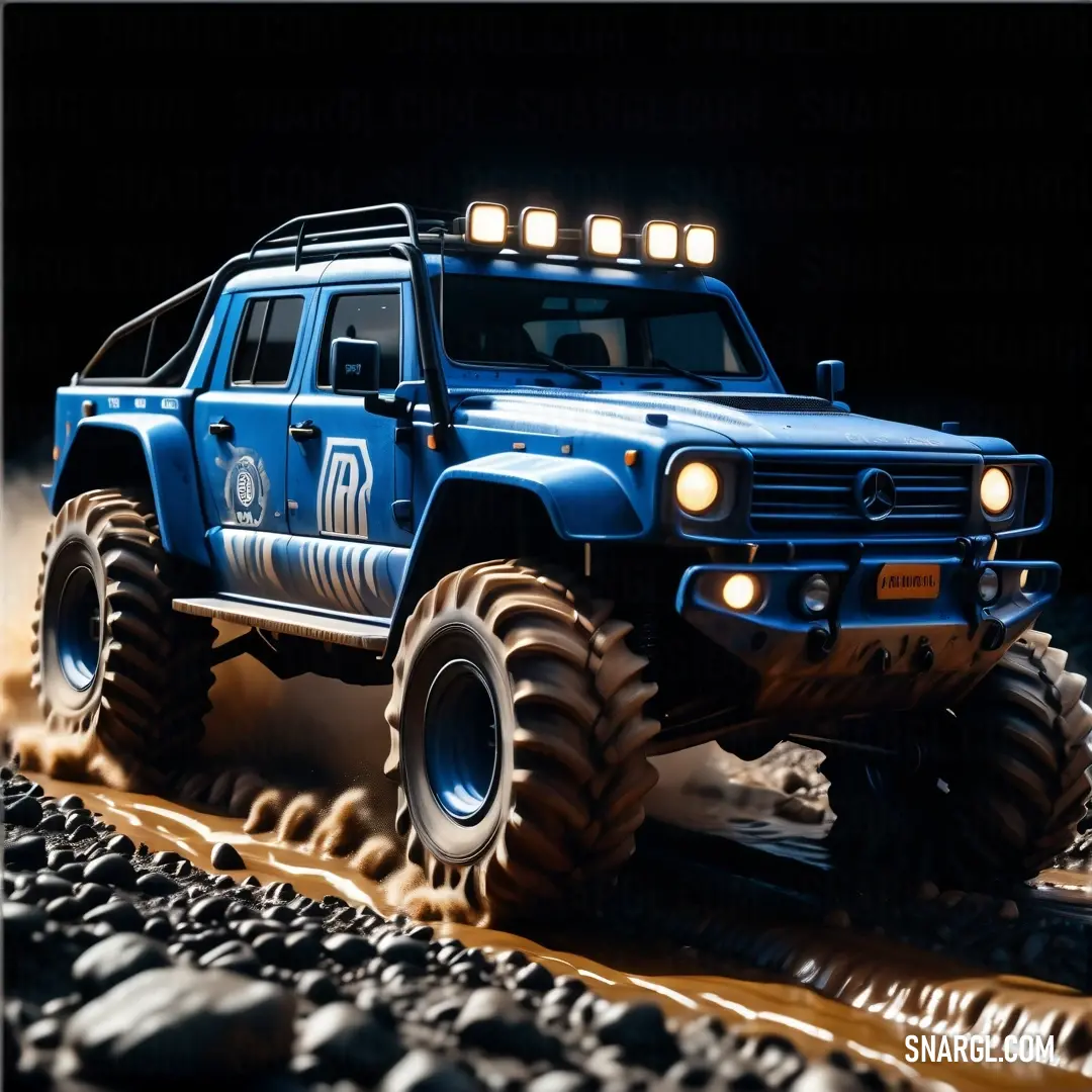 Blue truck with lights on driving on rocks and gravel in the dark with a black background