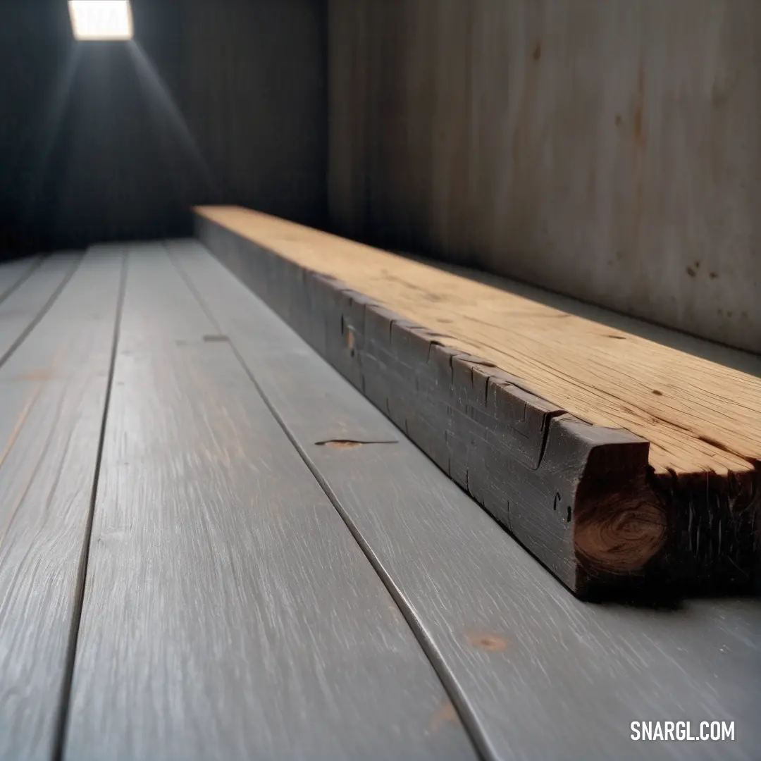 Wooden bench with a light shining on it's side and a beam of wood on the floor. Example of #696969 color.