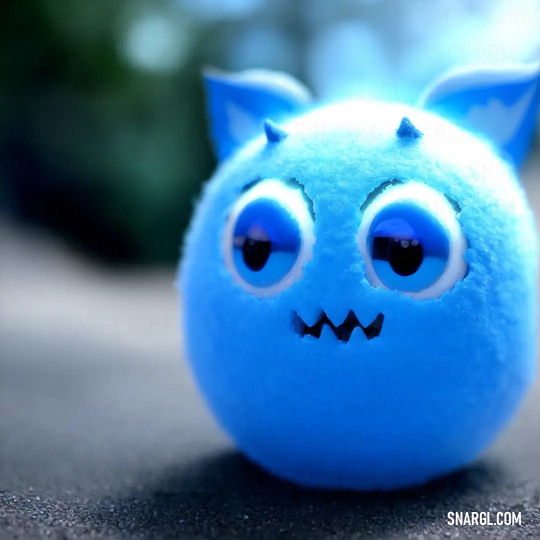 Blue ball with a face and eyes on it's side on a table with a blurry background