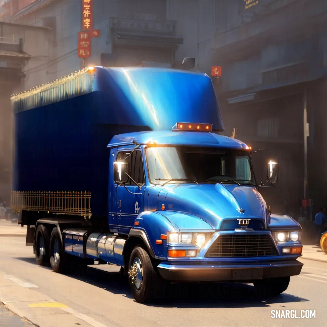 Blue semi truck driving down a street next to a tall building with a neon light on it's side