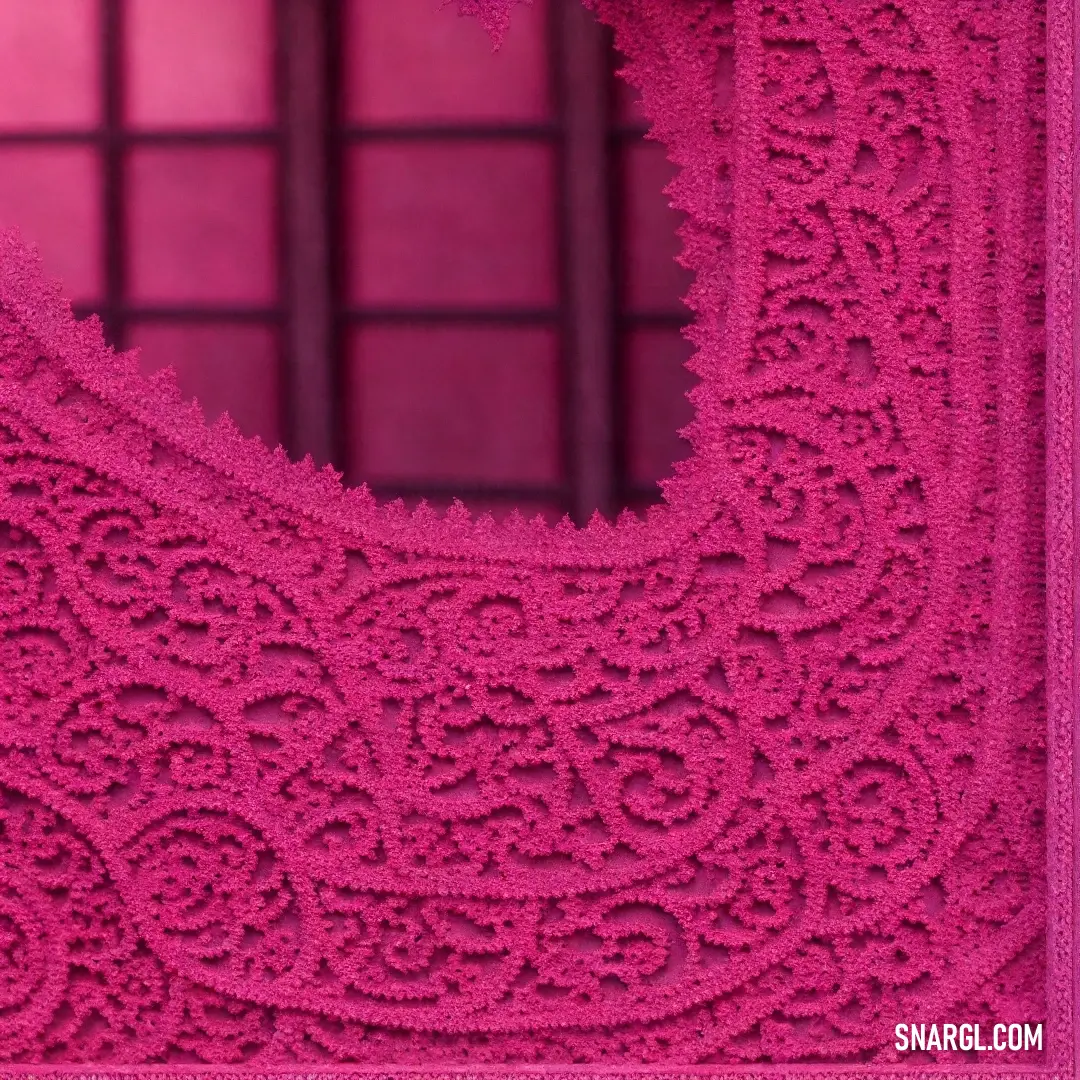 Pink doily with a heart shaped design on it's side and a window behind it with a pink background. Color CMYK 0,89,52,16.