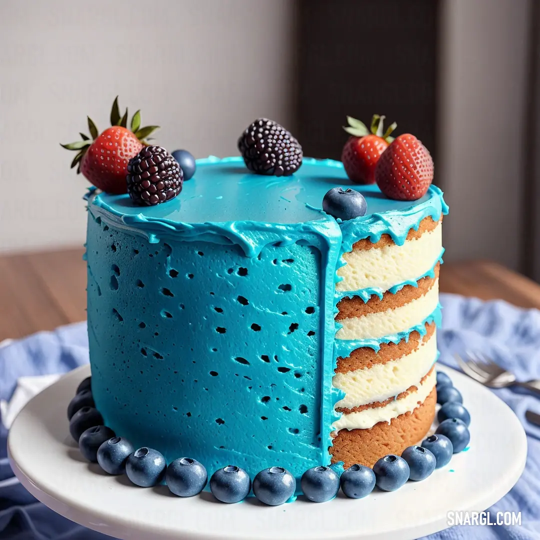 Blue cake with berries on top of it on a plate with a fork and knife on the side
