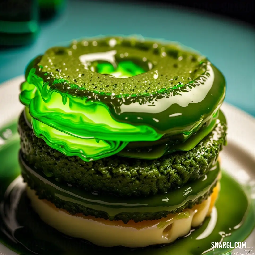 Green donut covered in green icing on a plate with a green liquid swirl on top of it