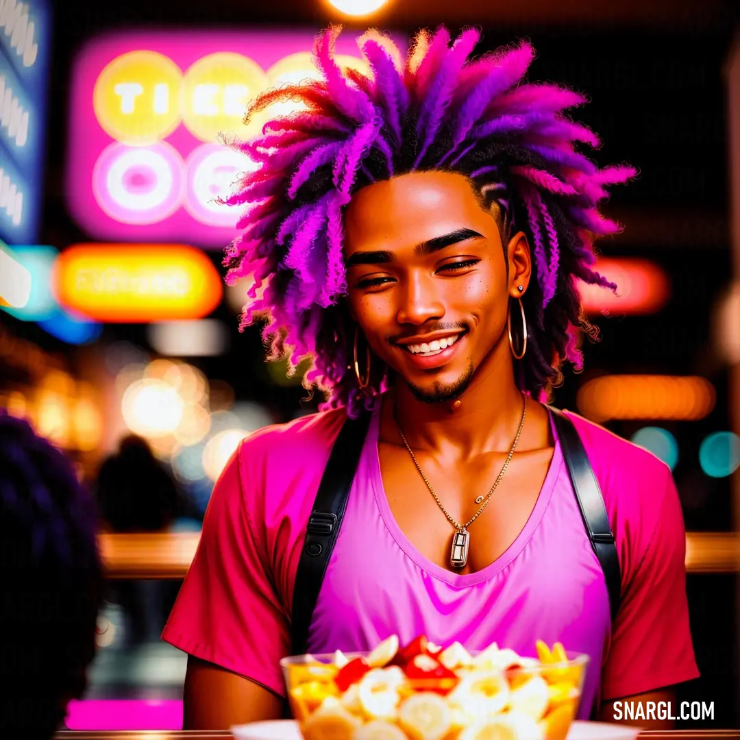 Man with a pink shirt and a bowl of food in front of him with purple dreadlocks