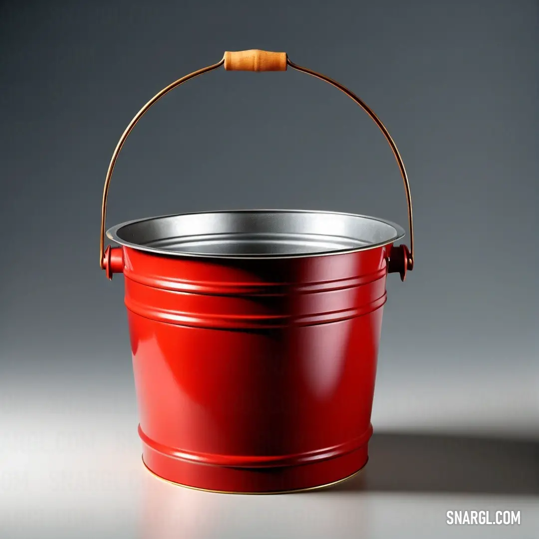 Red bucket with a wooden handle on a gray background. Example of Fire engine red color.