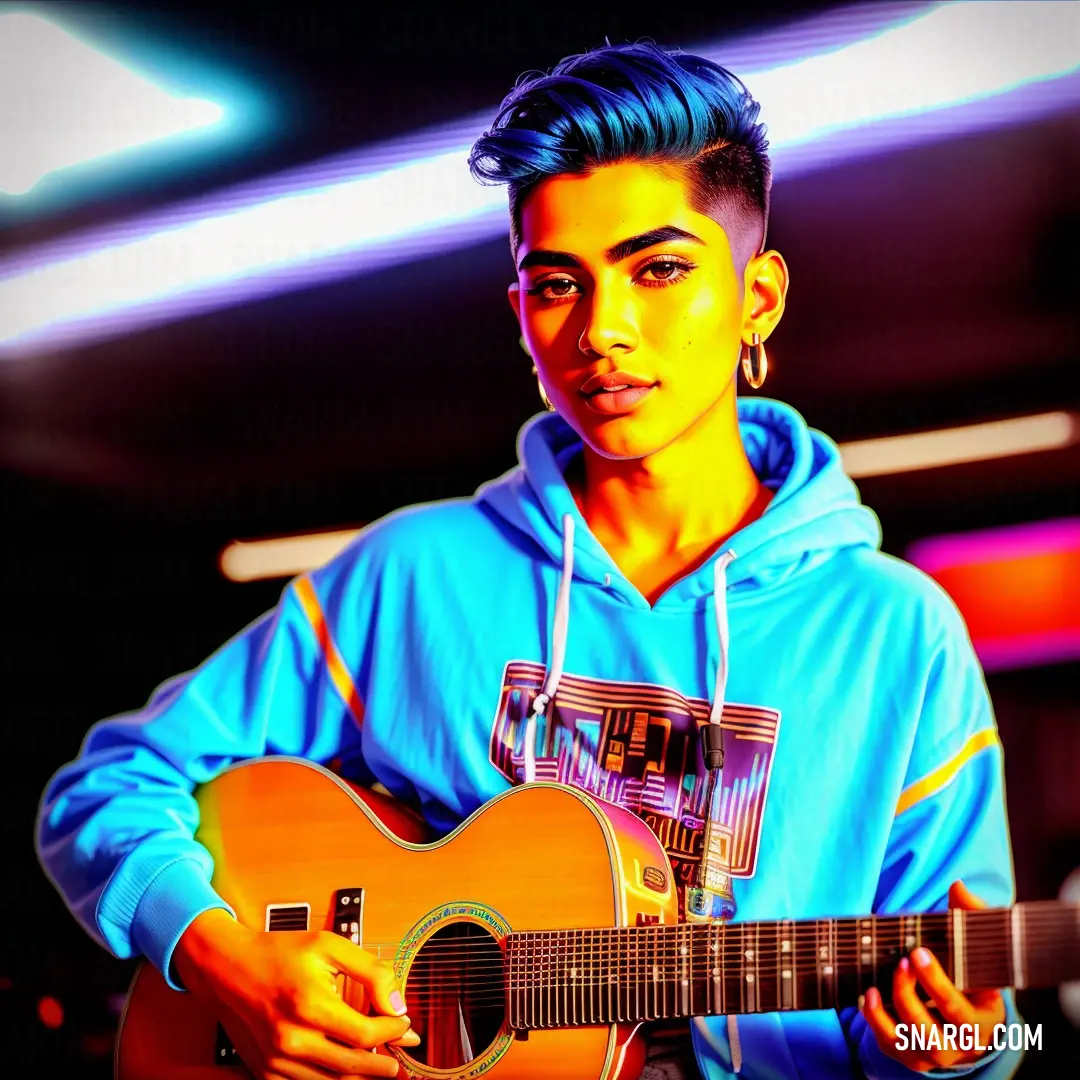 Man with a blue hoodie holding a guitar in his hands and looking at the camera